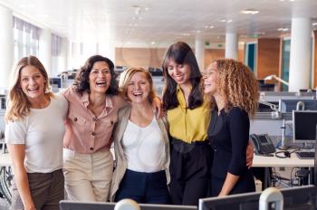 Portrait Of Smiling Female Business Team Working In Modern Office Together