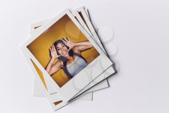 Stack Of Instant Film Photos From Modeling Casting In Studio With Shot Of Young Woman On Top