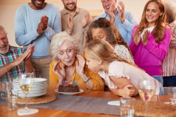 Multi-Generation Family Meet To Celebrate Grandmothers Birthday At Home Together
