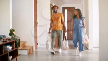 Couple Carrying Reusable Cotton Shopping Bags Retuning Home