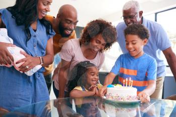 Multi-Generation African American Family Celebrating Daughters Birthday At Home Together