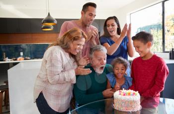 Multi-Generation Hispanic Family Celebrating Granddaughters Birthday At Home Together
