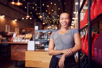 Portrait Of Female Coffee Shop Owner Standing By Counter