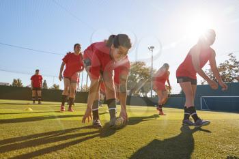 Womens Football Team Training For Soccer Match On Outdoor Astro Turf Pitch