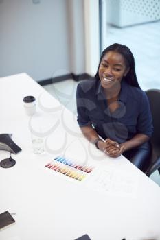 High Angle View Of Smiling African American Businesswoman Sitting At Table In Office  Meeting Room