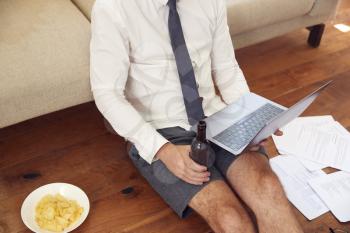 Businessman At End Of Day With Beer Wearing Loungewear And Shirt And Tie On Laptop Working From Home
