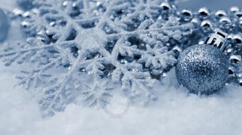 Christmas snowflake decoration nestled in snow
