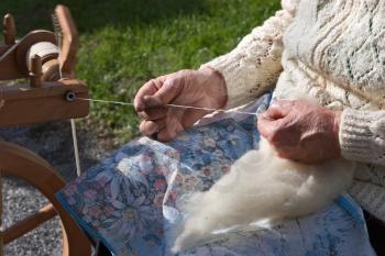 Royalty Free Photo of a Woman Spinning Yarn