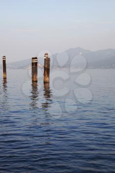 Mooring rusty piles in the port resort town on Lake Maggiore
