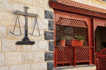 Original decoration stone wall and a carved wooden balcony. Ancient Circassian village of Kafr Kama in Israel
