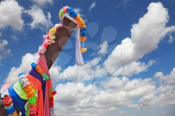 Beautifully decorated with colored silks Native Longtail boat is oriented in the sky