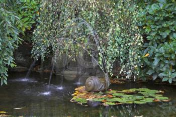  A charming fountain in the form of a snail in a small pond