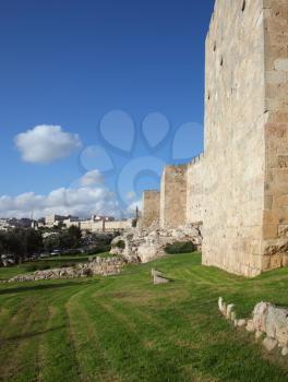 A lovely sunny day in Jerusalem. The walls and towers against the sky and clouds
