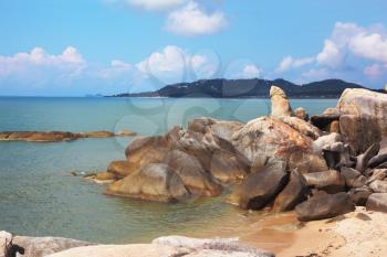 The Thai island Samui. A picturesque heap of rocks on the seacoast, shined with the sunset sun
