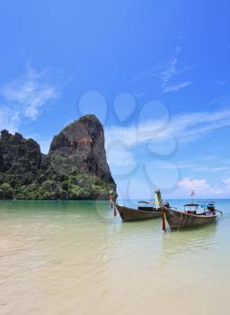 Two beautiful, richly decorated with antique boat Longtail on a beach in Thailand
