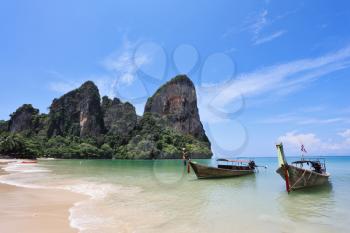 Two richly decorated antique boat Longtail on a beach in Thailand
