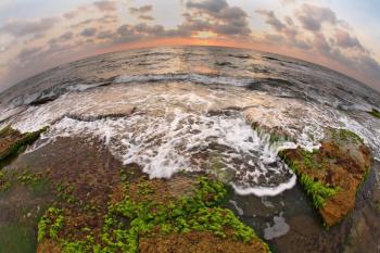The Mediterranean Sea at low tide, photographed lens Fisheye. Sunset