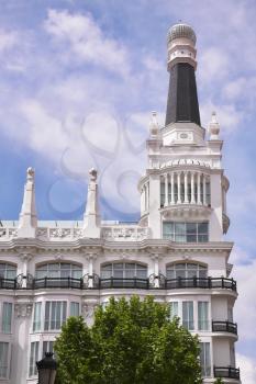 Magnificent ancient snow-white building in the center of Madrid