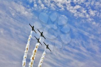 Synchronous  flight of four sparkling planes on air parade 