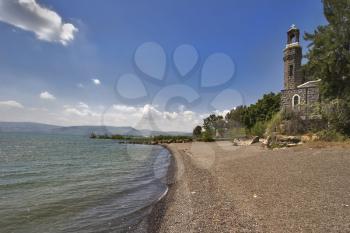  Ancient church and trees at coast of lake of Tiberias in the spring 