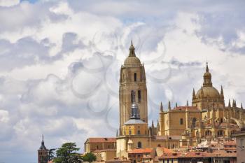 Tower of a cathedral in Segovia on a background of the cloudy sky