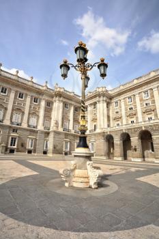The magnificent Royal Palace in Madrid. Lanterns in the Baroque style adorn the Palace Square