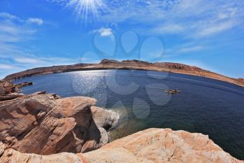 The midday sun in the turquoise water bay. Bottling magnificent Lake Powell photographed by Fisheye lens