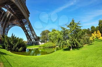 Touring Paris. Park at the foot of the Eiffel Tower. Unexpected angle Fisheye lens takes