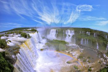 Boiling water foam, crashing and falling jets, a fine mist over the water. The waterfall in the world - Iguazu. The Brazilian side