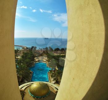 Swimming pool on coast of Red sea, photographed from a window of magnificent hotel