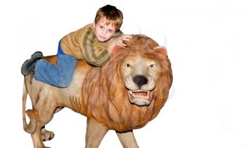 
Happy boy is riding a lion statue

