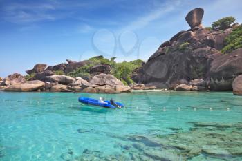 Exotic tropical Similan Islands. Clear azure ocean water. Moored in the bay inflatable boat