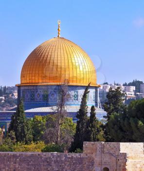 Golden Dome Mosque of Caliph Omar. The Holy City of Jerusalem is lit by the morning sun.