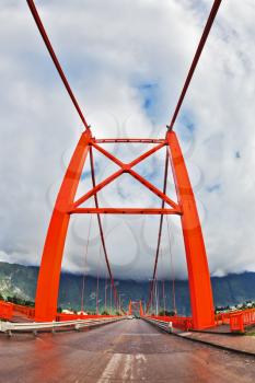 Red bridge over the fjord. Recently, there was a thunderstorm. Patagonia, Chile. The picture was taken Fisheye lens