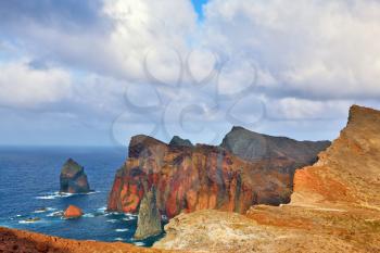 Easternmost tip of the island of Madeira. It is red and orange rocks coolly grow from foamy waves of the Atlantic Ocean