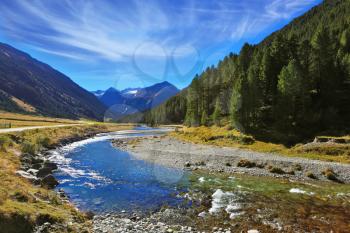 Austrian Alps. Headwaters of the famous Krimml waterfalls. The crystal clear transparent water glows in the midday sun