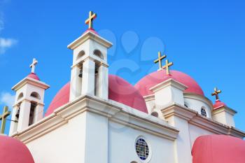 White walls, pink domes and golden crosses the Orthodox Church of the Twelve Apostles on the shore of Lake Kinneret.
