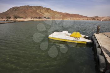 Boat at a mooring in small lake in desert