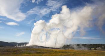 The well-known boiling geothermal geyser in Yellowstone national park - Old Faithful. Eruption comes to an end