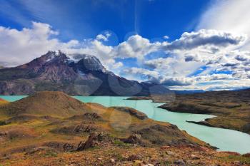 Emerald waters of Lake Pehoe at rocks Los Kuernos. National Park Torres del Paine, Patagonia, Chile