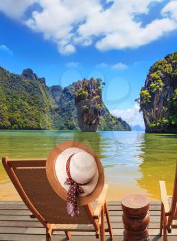 Exotic rest in Thailand. The coast of the gulf in the Andaman Sea. Convenient chaise lounge and an elegant hat on one