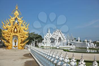Fabulously beautiful white palace and richly gilded chapel in the style of the new Thai architecture