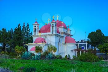  Pink domes and golden crosses crowned with snow-white church building. Greek church of the Cathedral of the twelve apostles in Israel