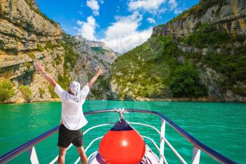 Travel on the river Verdon. The enthusiastic tourist on  boat with red lantern