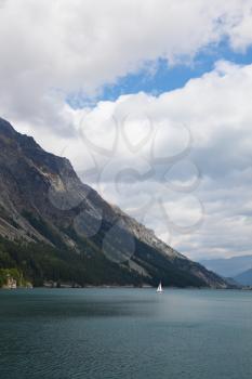 The magnificent sailing yacht on mountain lake. The Swiss Alpes, early autumn