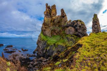  Picturesque rocks covered with moss green and yellow. Gorgeous Iceland. Northern Atlantic coast