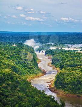 The Iguazu Falls on the Brazilian-Argentine border. Waterfalls are located in the two national parks - Argentina and Brazil in the dense tropical forests. Picture taken from a helicopter