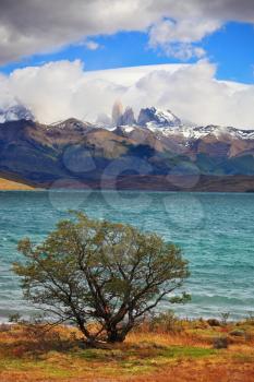 The gale on the Emerald Lake. Thundercloud closes the sky. In the distance the mountains with snow-capped