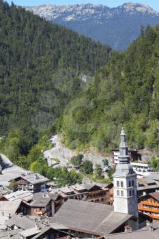 French Alps. Church steeple towers over the small town of Green Mountains