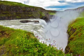 Water abyss. Scenic Gullfoss in Iceland. Over boiling water should cloud splash